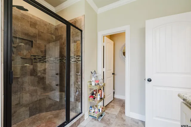 a bedroom with a bed a chandelier and a window