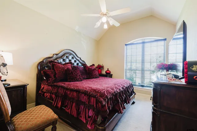 a bedroom with a bed and a chandelier