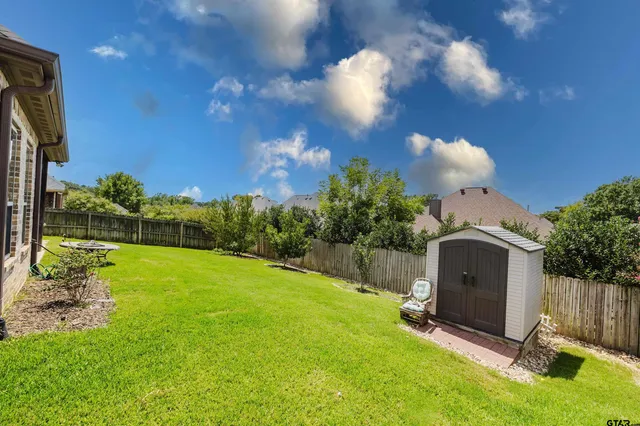 a view of a patio with table and chairs a barbeque with wooden fence