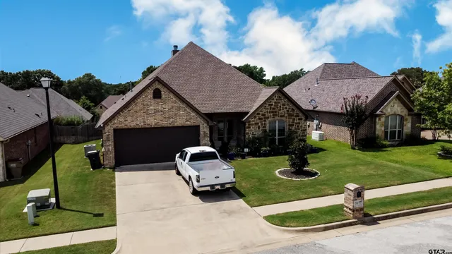 an aerial view of a house with garden space and street view