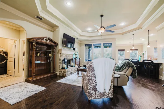 a living room with furniture and a chandelier