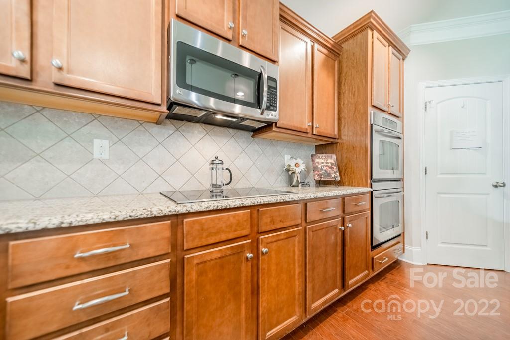 79109 Ridgehaven Road Lancaster, SC 29720 - Photo 11 of 48 a kitchen with stainless steel appliances granite countertop a sink a stove and a microwave oven
