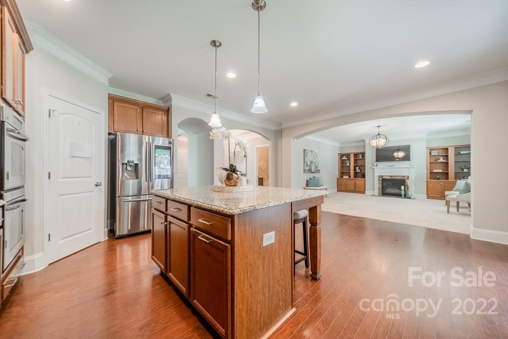 79109 Ridgehaven Road Lancaster, SC 29720 - Photo 13 of 48 a kitchen with stainless steel appliances granite countertop a refrigerator a sink dishwasher a oven and a dining table with wooden floor