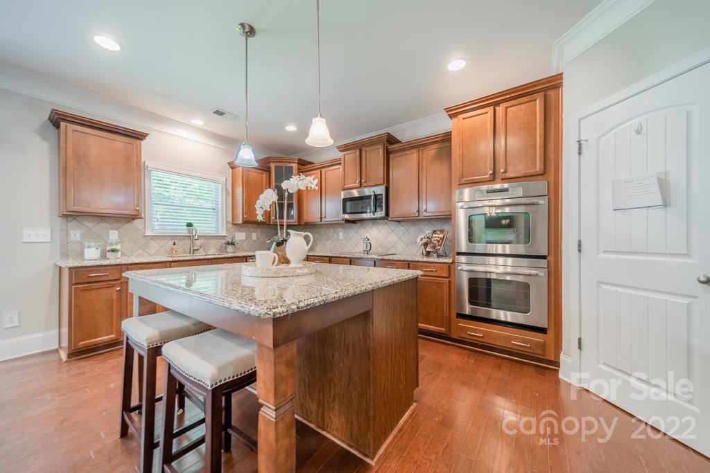 79109 Ridgehaven Road Lancaster, SC 29720 - Photo 14 of 48 a kitchen with stainless steel appliances granite countertop a stove refrigerator sink and cabinets