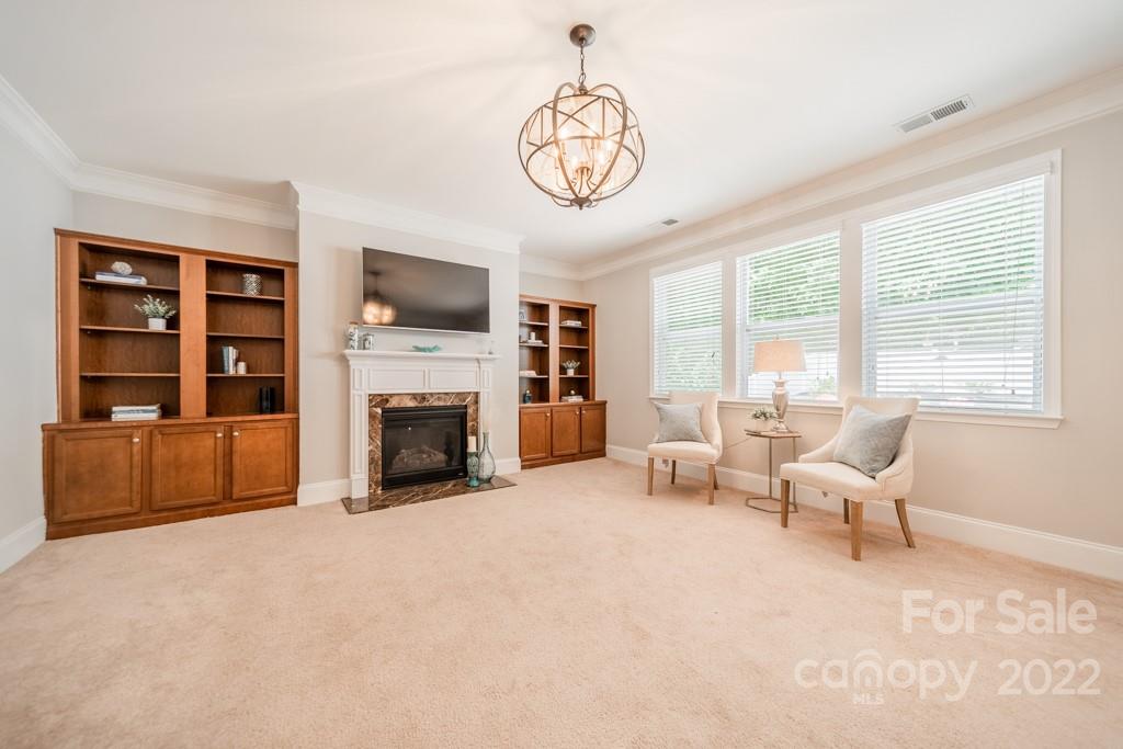 79109 Ridgehaven Road Lancaster, SC 29720 - Photo 15 of 48 a living room with furniture a fireplace and a flat screen tv