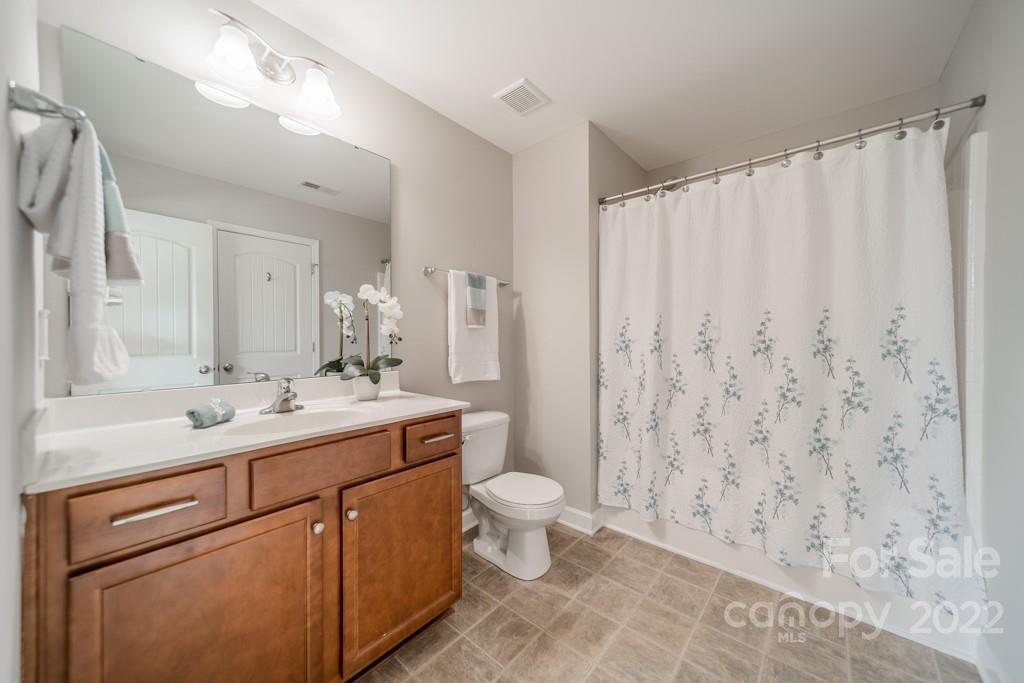 79109 Ridgehaven Road Lancaster, SC 29720 - Photo 35 of 48 a bathroom with a sink a toilet and shower curtain
