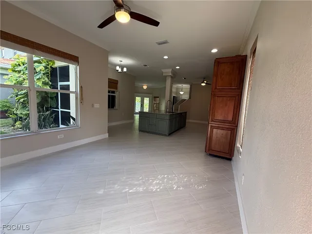a living room with furniture and a kitchen