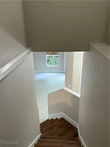 a view of a room with wooden floor
