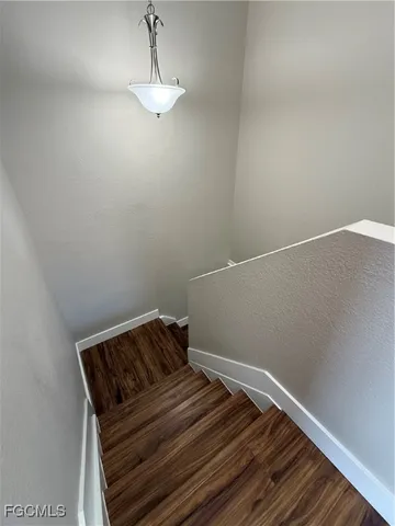 a view of a livingroom with furniture and a refrigerator