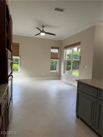 an empty room with a fireplace and windows