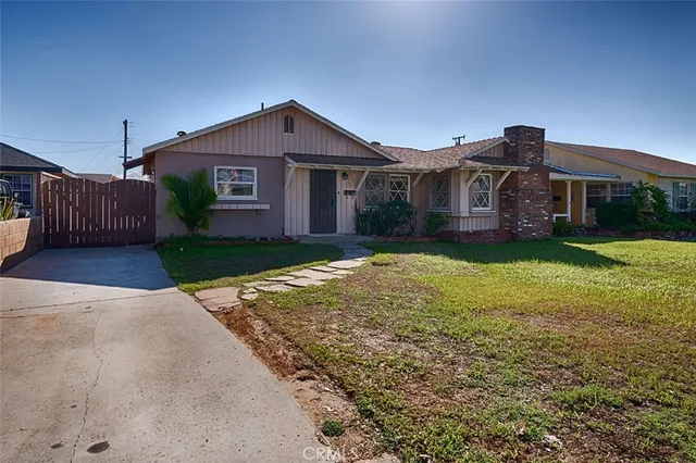 a front view of a house with yard and garage