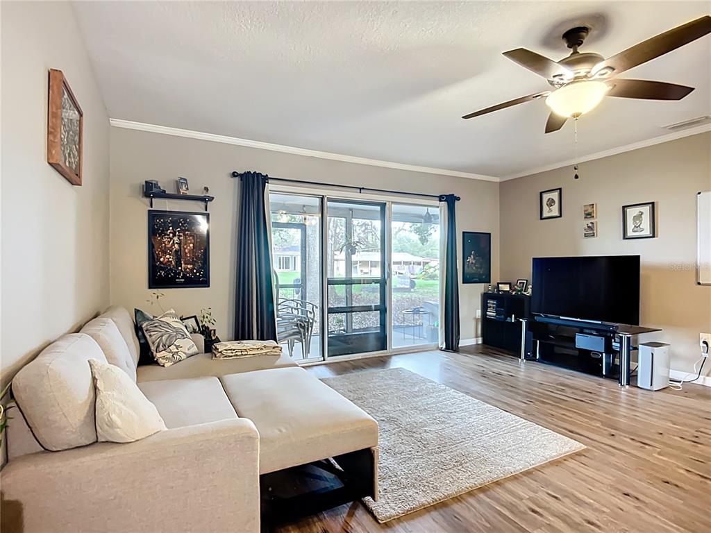 1304 Alfred Street, Unit A Brandon, FL 33510 - Photo 16 of 25 a bedroom with a bed a flat screen tv and a large window