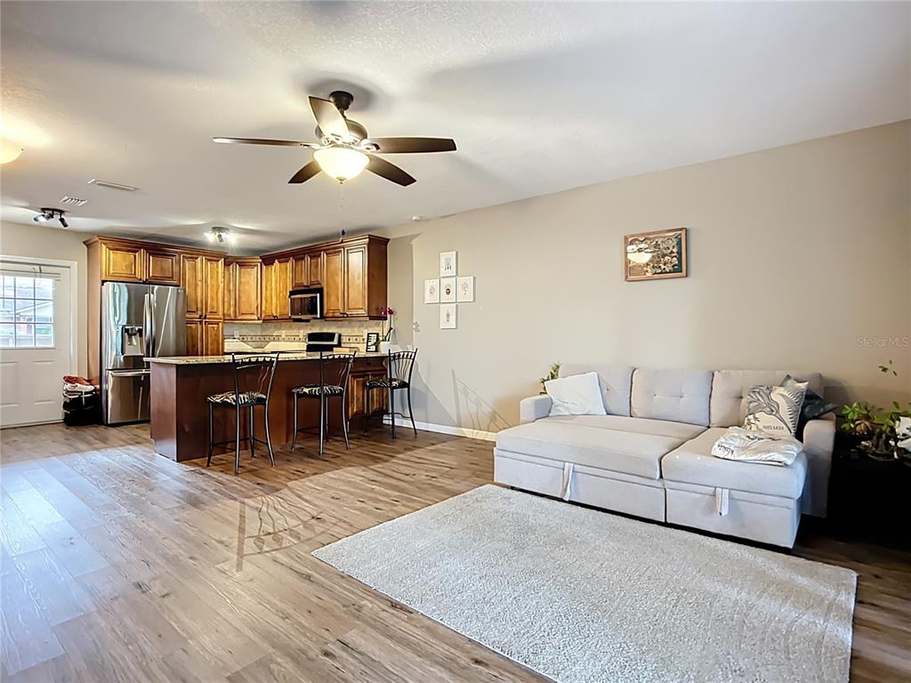 1304 Alfred Street, Unit A Brandon, FL 33510 - Photo 17 of 25 a living room with stainless steel appliances kitchen island granite countertop furniture and a kitchen view