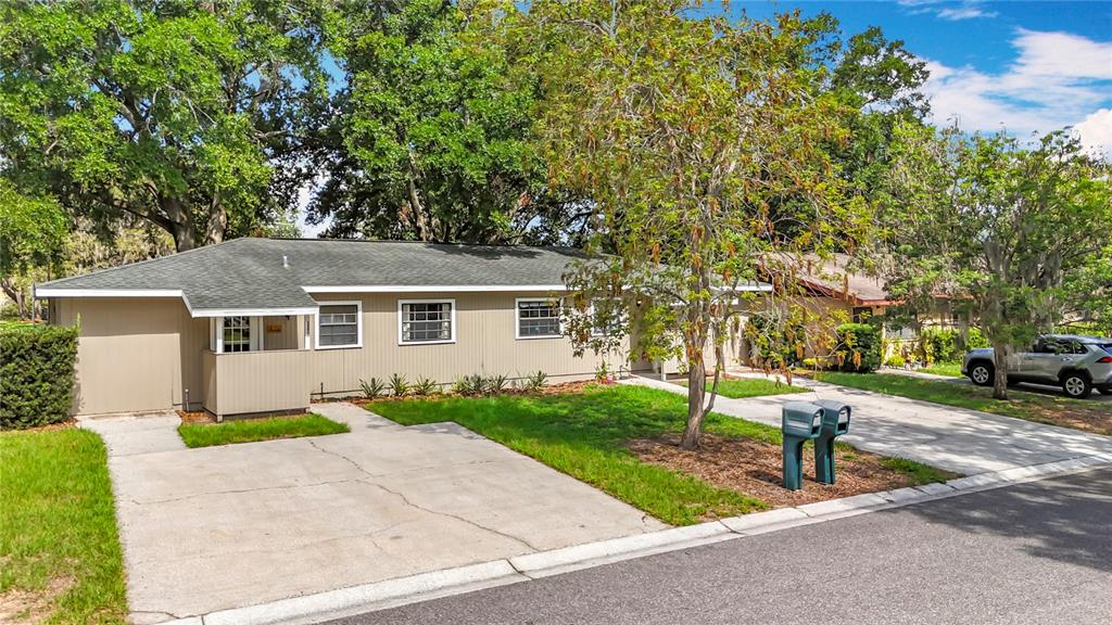 1304 Alfred Street, Unit A Brandon, FL 33510 - Photo 3 of 25 a front view of a house with a garden and trees