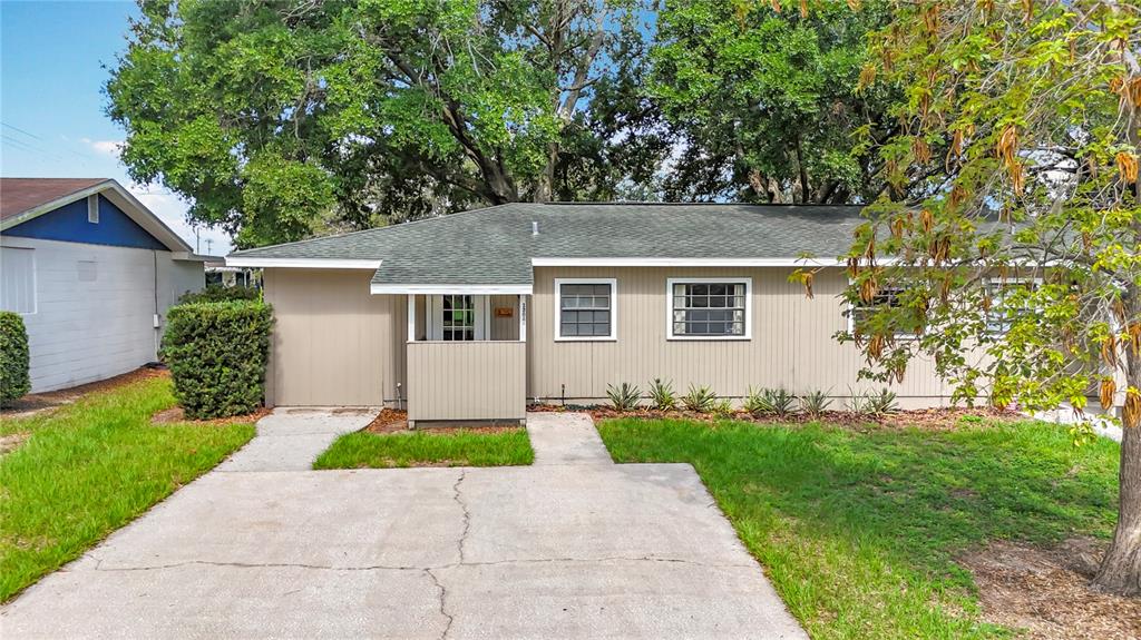 1304 Alfred Street, Unit A Brandon, FL 33510 - Photo 6 of 25 a front view of a house with a yard and trees