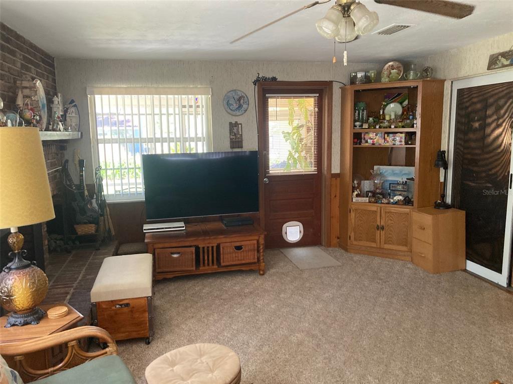 1126 Stevens Avenue DeLand, FL 32720 - Photo 15 of 38 a living room with furniture and a flat screen tv
