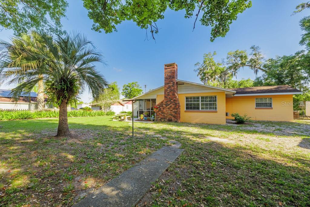 1126 Stevens Avenue DeLand, FL 32720 - Photo 27 of 38 a view of a house with a yard and palm trees