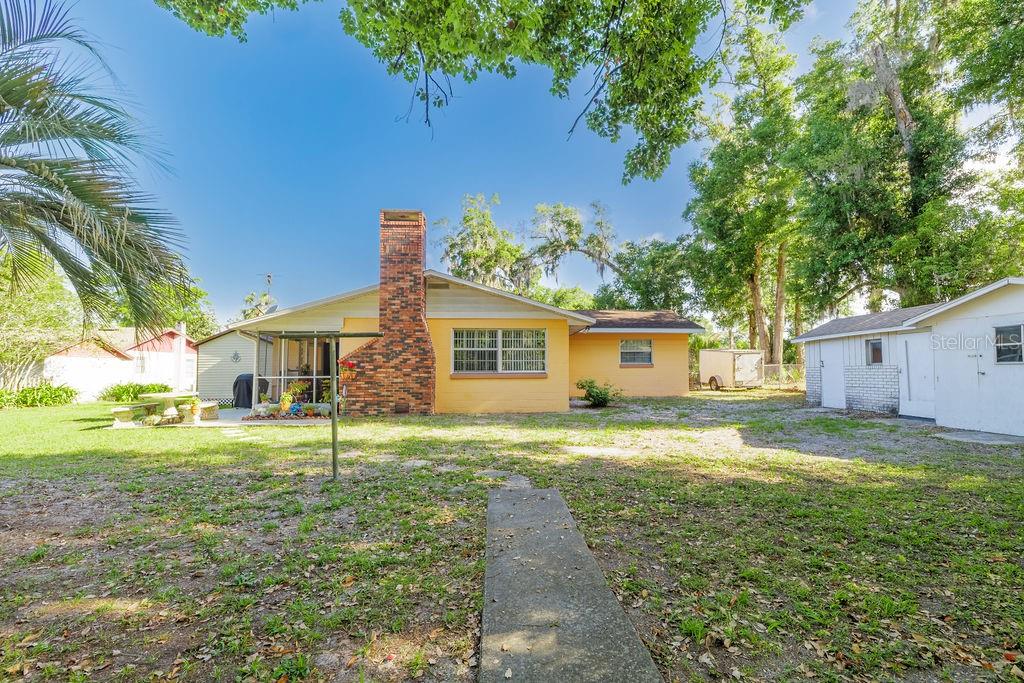 1126 Stevens Avenue DeLand, FL 32720 - Photo 30 of 38 a view of a yard in front of a house with a large tree