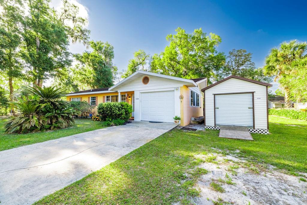 1126 Stevens Avenue DeLand, FL 32720 - Photo 3 of 38 a view of a house with a yard and large tree