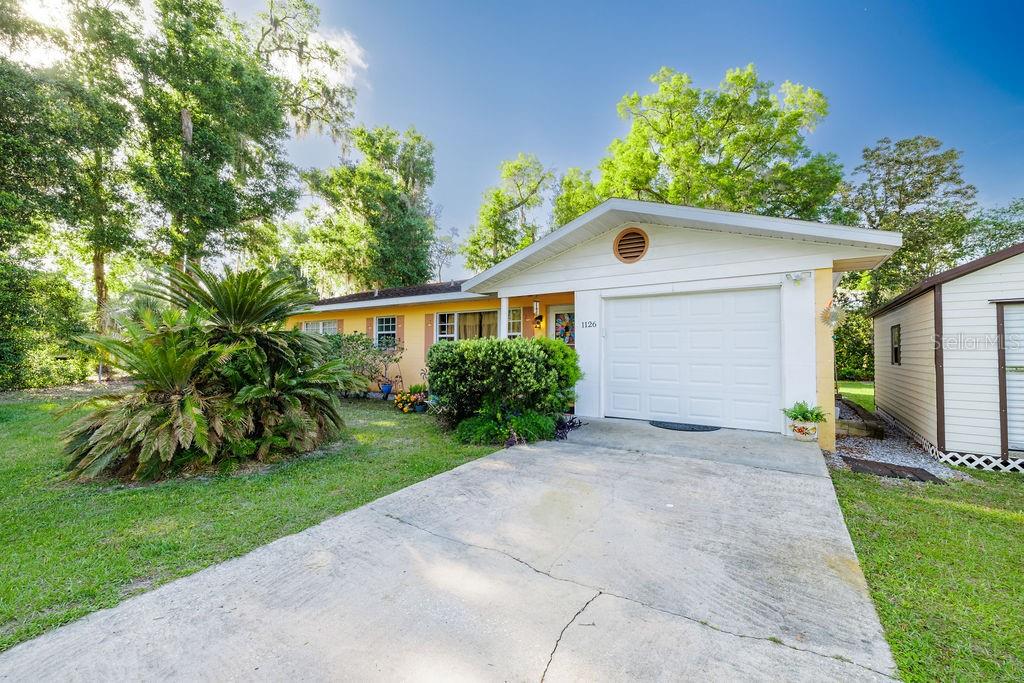 1126 Stevens Avenue DeLand, FL 32720 - Photo 34 of 38 a front view of a house with a yard