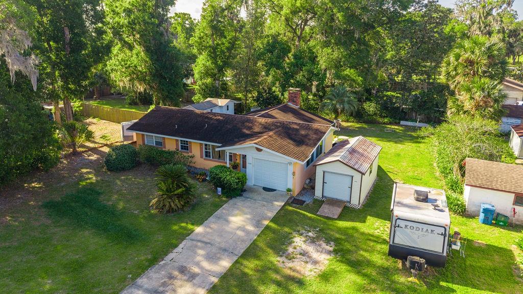 1126 Stevens Avenue DeLand, FL 32720 - Photo 37 of 38 aerial view of a house with a big yard potted plants and large trees