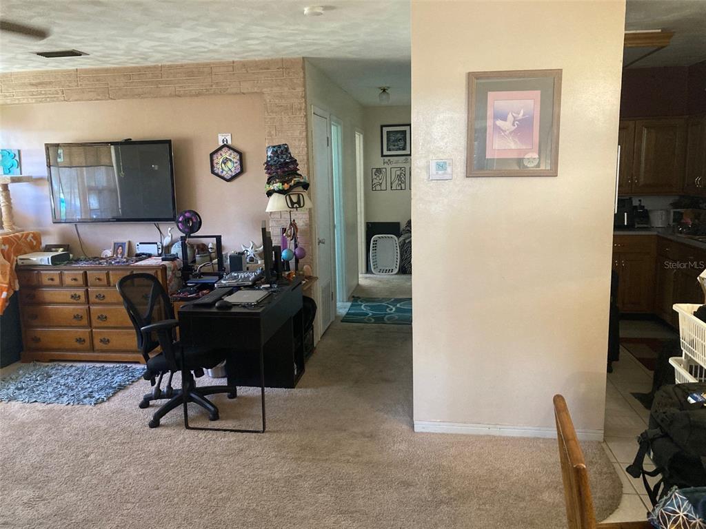 1126 Stevens Avenue DeLand, FL 32720 - Photo 6 of 38 a living room with furniture and a flat screen tv