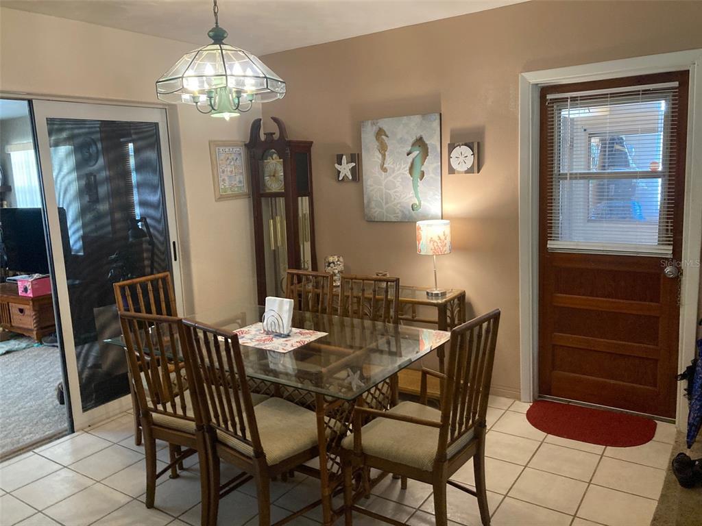 1126 Stevens Avenue DeLand, FL 32720 - Photo 7 of 38 a view of a dining room with furniture and chandelier