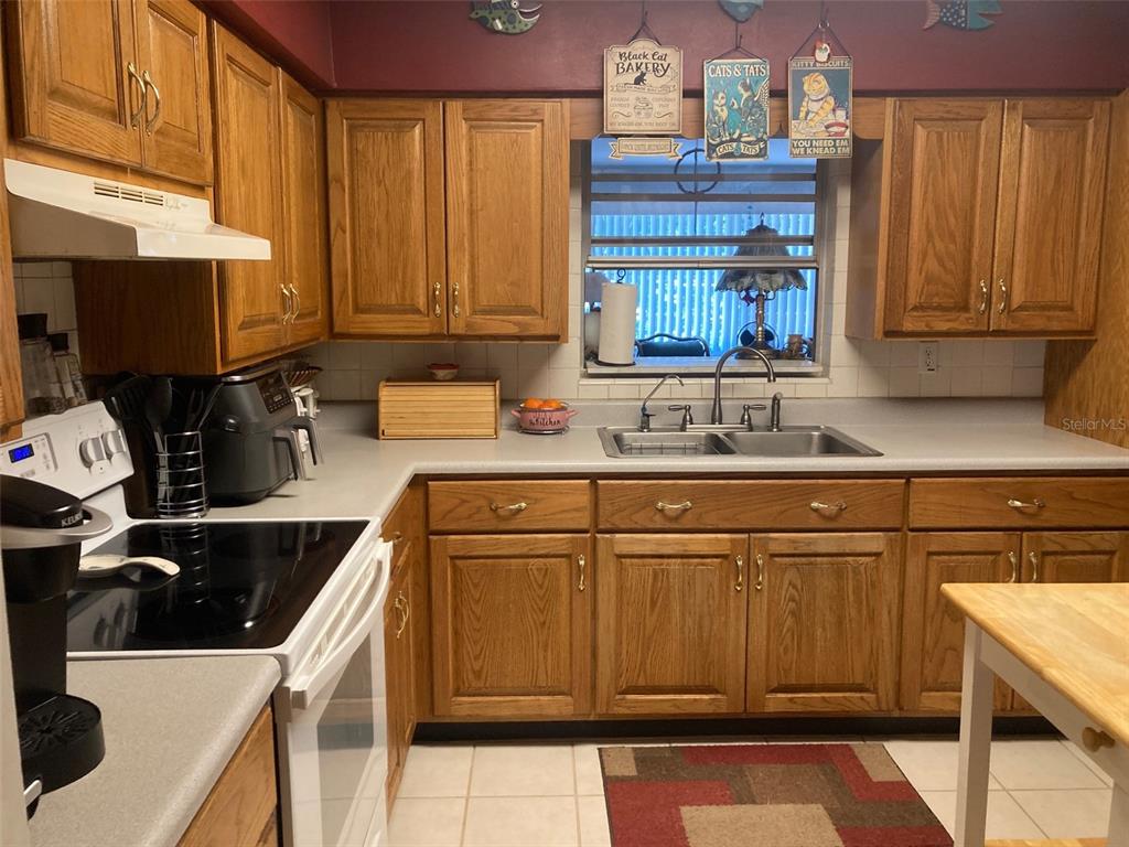 1126 Stevens Avenue DeLand, FL 32720 - Photo 8 of 38 a kitchen with a sink and a stove top oven