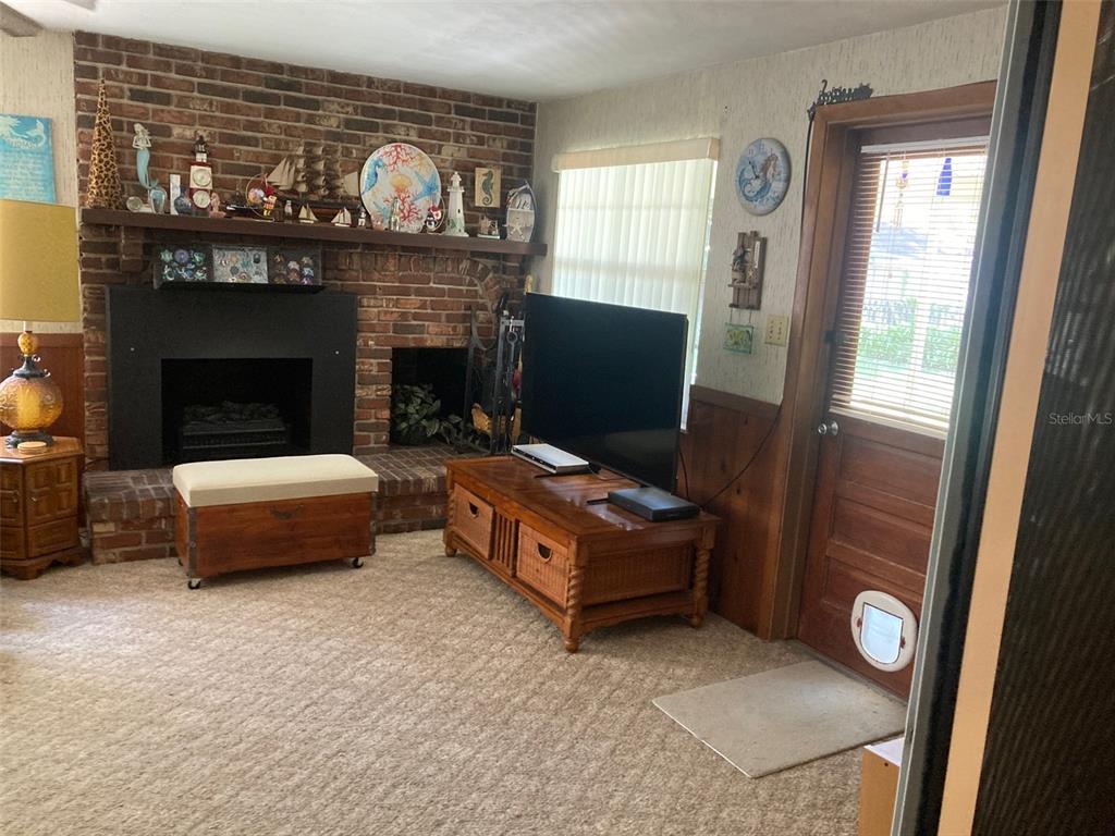 1126 Stevens Avenue DeLand, FL 32720 - Photo 10 of 38 a living room with furniture and a fireplace