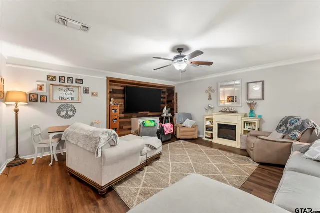 a living room with furniture a fireplace and a flat screen tv