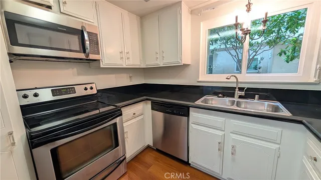 a kitchen with stainless steel appliances granite countertop a sink and cabinets