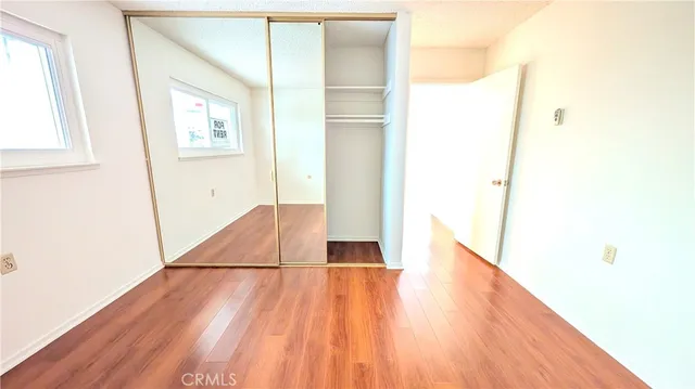 a view of a room with wooden floor and a window
