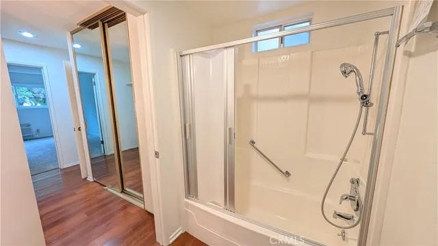 a bathroom with a glass shower door and a sink
