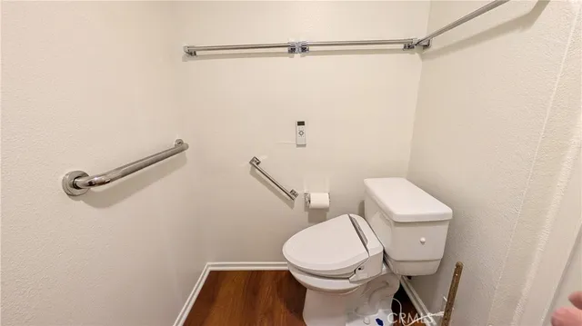 a white toilet sitting next to a shower