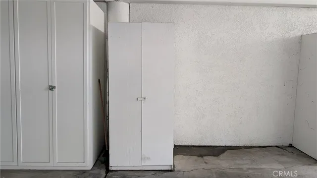 an empty room with wooden floor and a bathroom