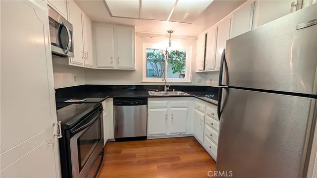 a kitchen with a sink a refrigerator and a stove
