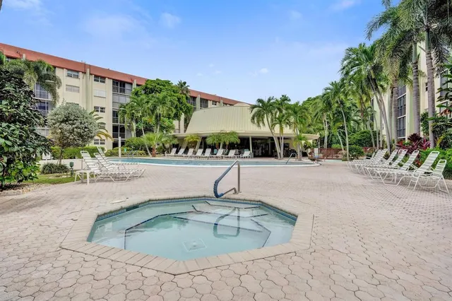 a swimming pool with outdoor seating and yard
