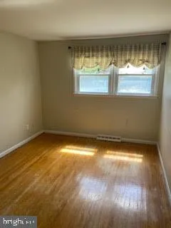 a view of a room with wooden floor