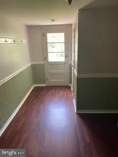 a view of room with hardwood floor and window