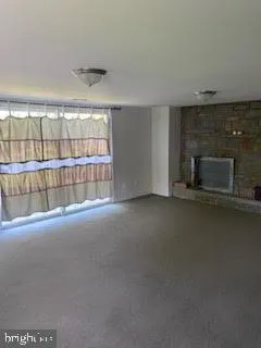 a view of empty room with fireplace