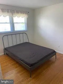 a bed sitting in a bedroom next to a window