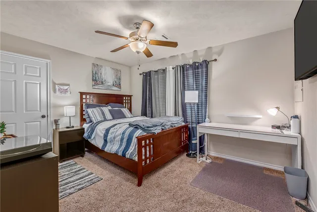 a bed sitting in a bedroom next to a window