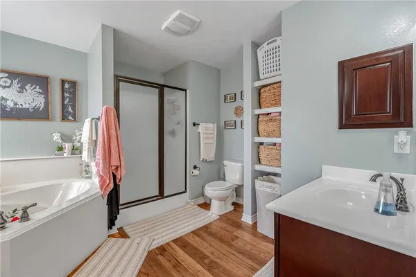 a spacious bathroom with a sink a toilet and a bathtub