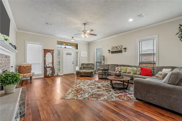 a living room with furniture and wooden floor