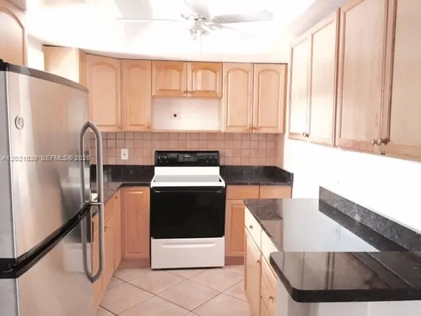 a kitchen with a stove a refrigerator and a sink