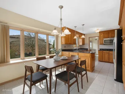 a kitchen with granite countertop a stove a sink and a refrigerator