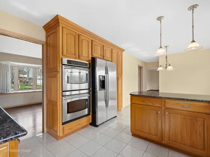 a kitchen with stainless steel appliances granite countertop a sink and cabinets