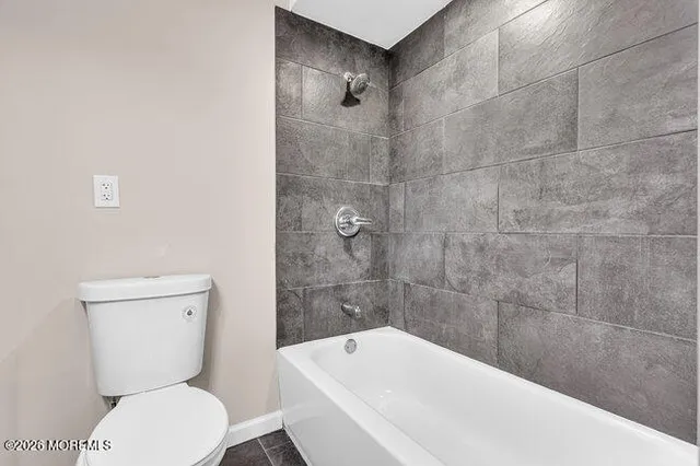 a bathroom with a toilet a sink and bathtub