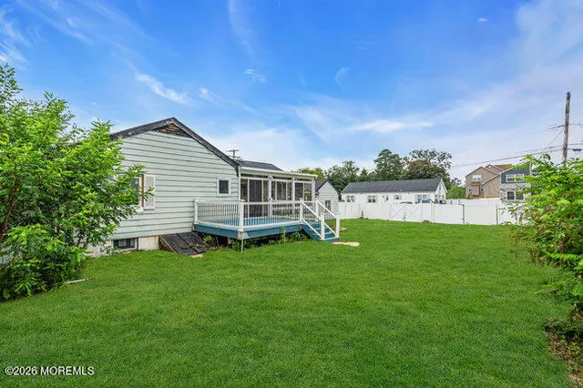 a view of a house with a backyard porch and sitting area