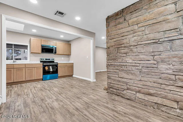 a view of kitchen with microwave and cabinets